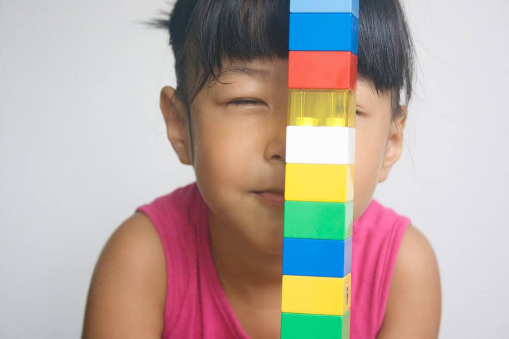 girl playing with legos