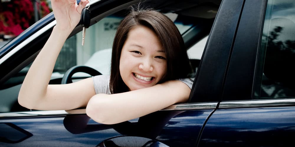 teen girl driving new car