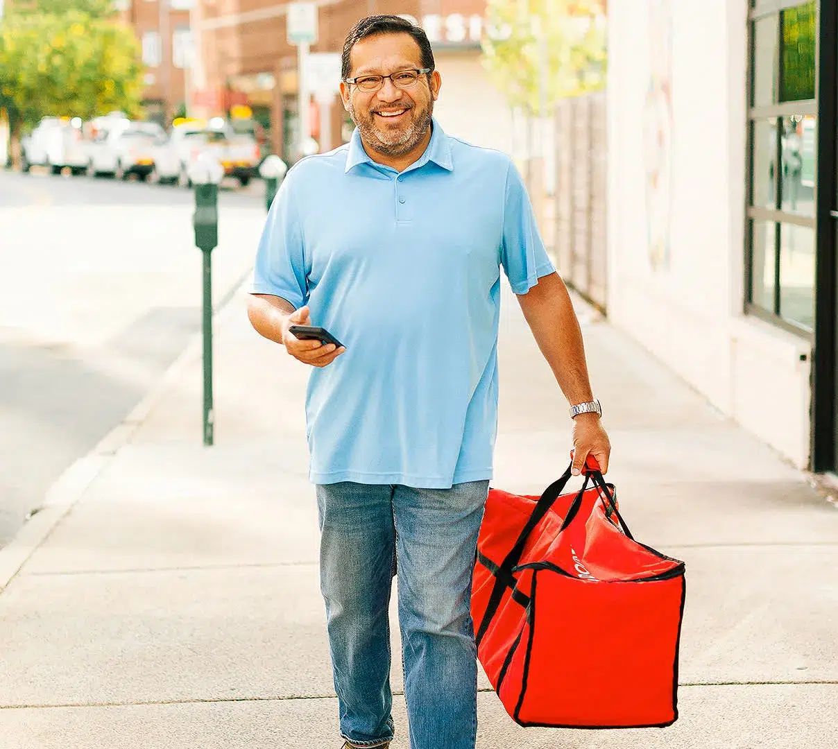 Man delivering food in a red bag, smiling