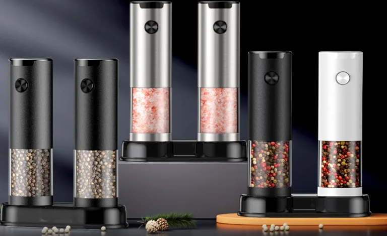 Electric salt and pepper grinders set on counter