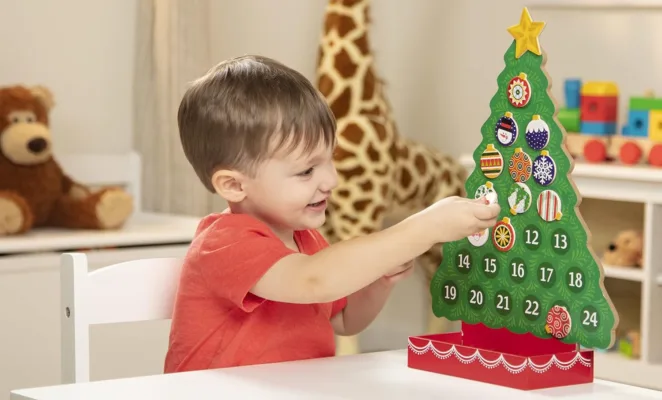 Child playing with Christmas advent calendar.