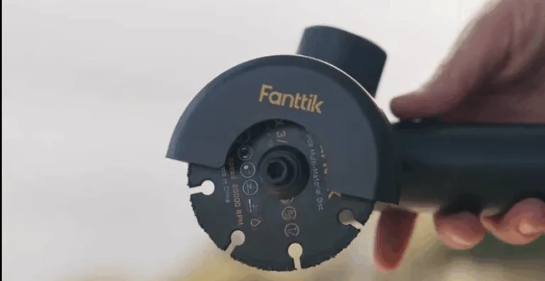 Hand holding Fanttik angle grinder tool