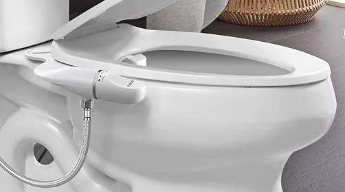 Modern bidet attached to toilet in bathroom