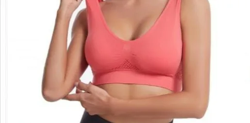 Woman modeling a coral sports bra