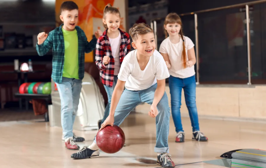 Children bowling and having fun at alley