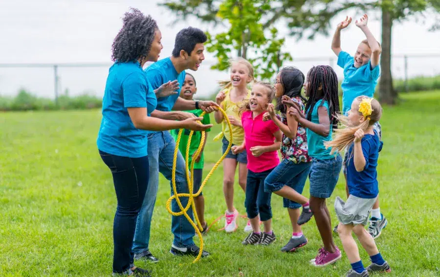 Children playing with rope outdoors.
