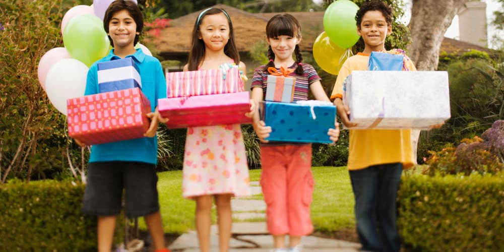 kids holding birthday gifts