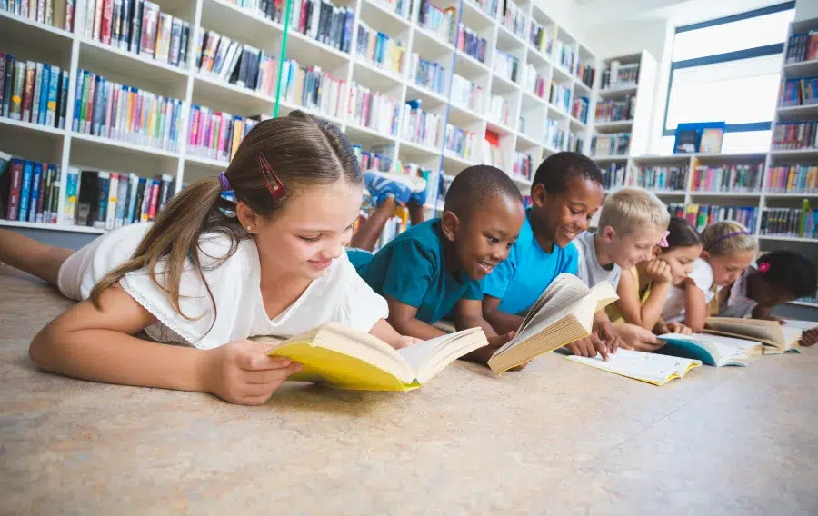 Children reading books in library