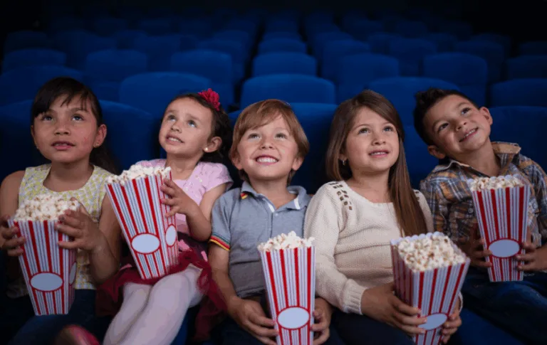 Children enjoying popcorn at the movie theater.