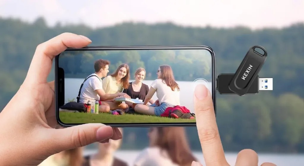 Person using phone with USB drive outdoors