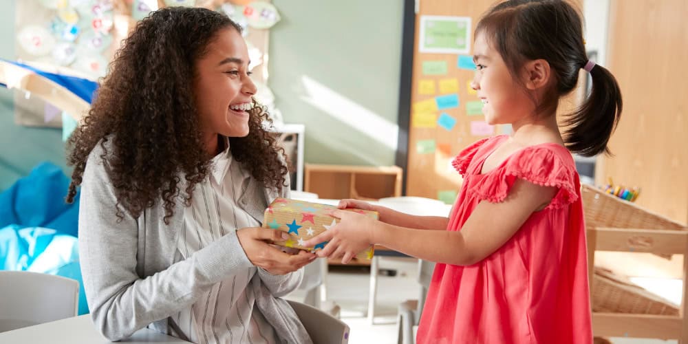 kid giving teacher gift