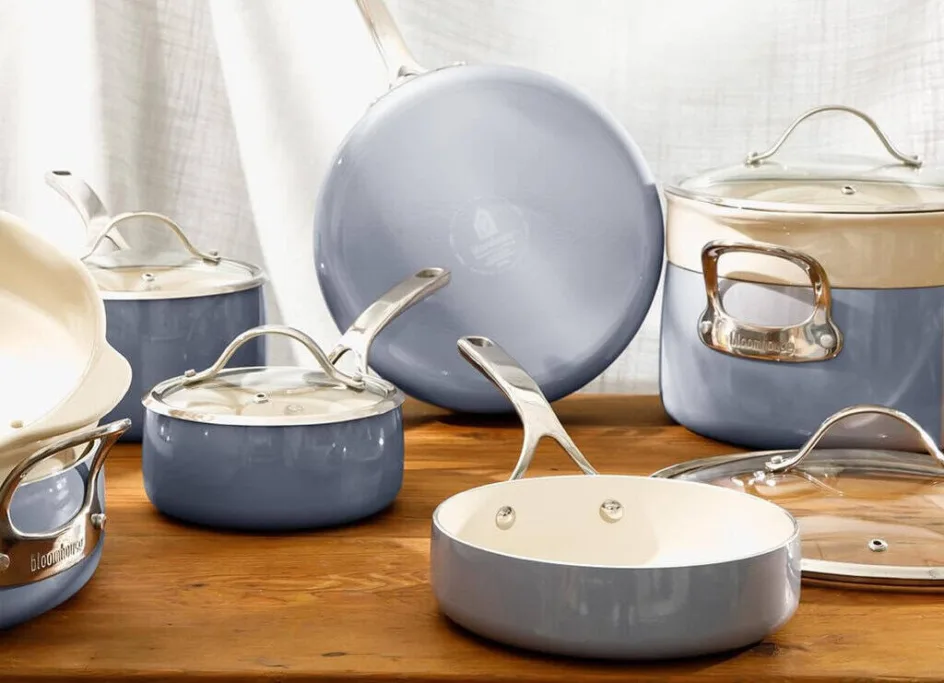 Blue ceramic cookware set on wooden table.