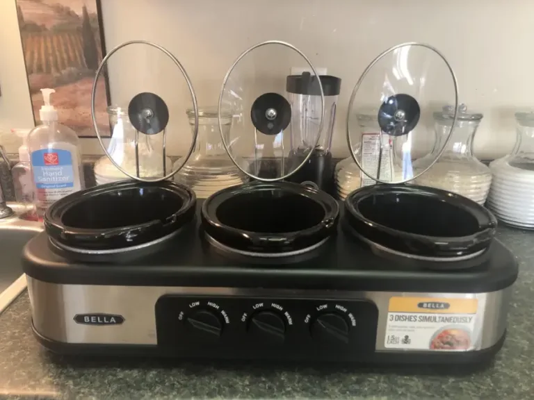 Three-section slow cooker with glass lids.