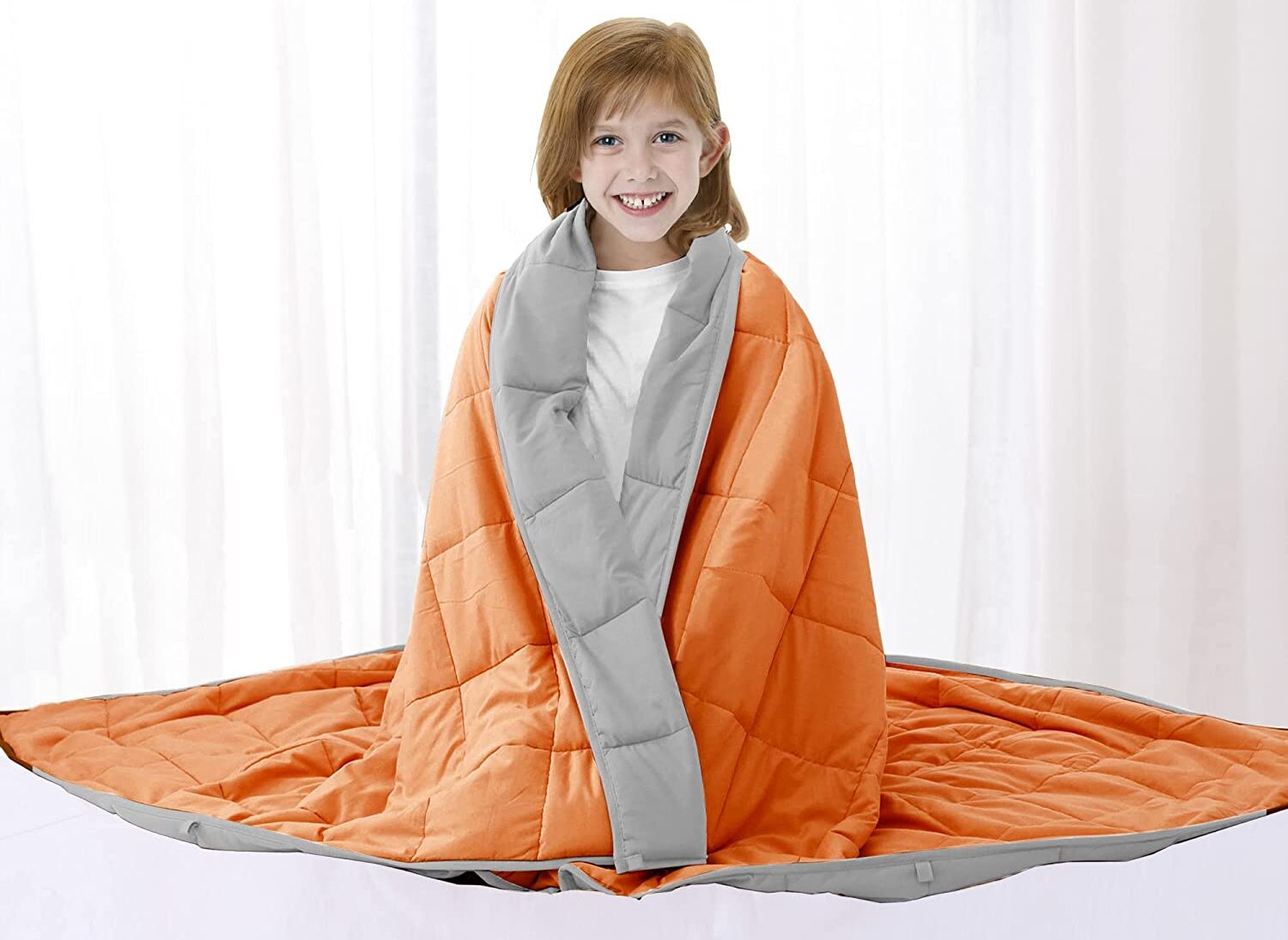 weighted blanket orange and grey with girl