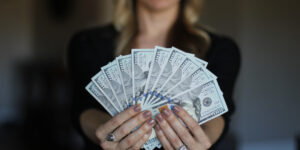 woman holding 1000 dollars money
