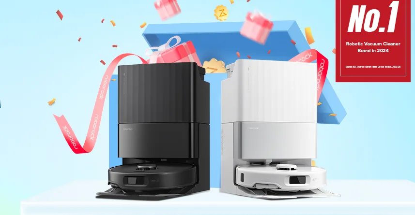 Two robotic vacuums with confetti and gift boxes.