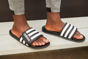 black adidas adilette on feet