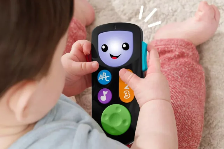 Baby playing with educational toy remote control.