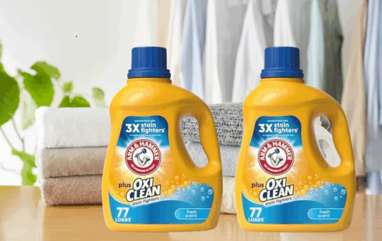 Laundry detergent with towels and clothes in background