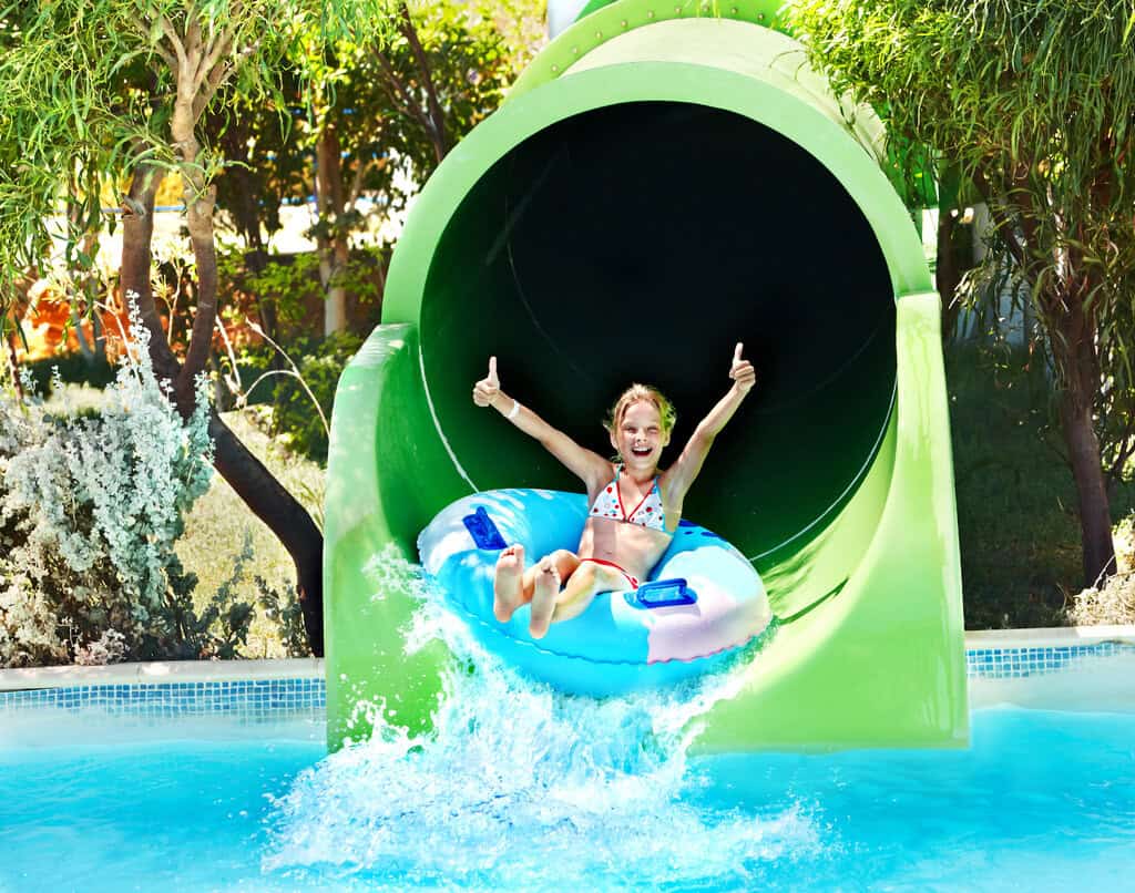 child on water slide at aquapark.