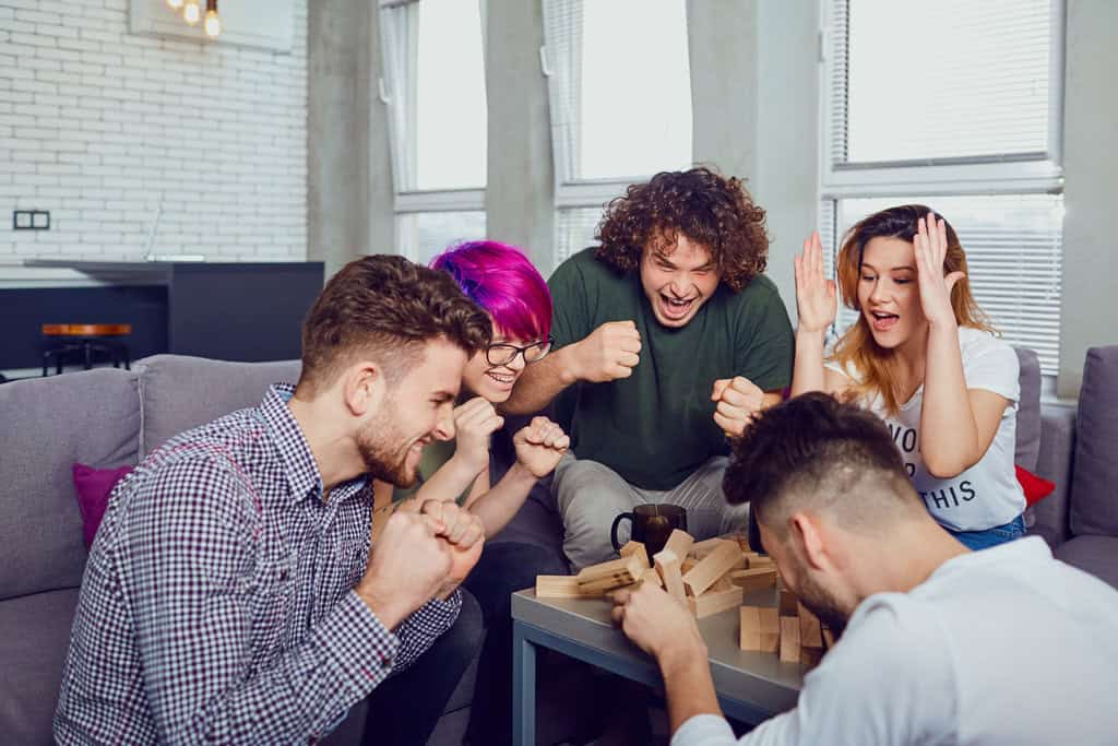 a cheerful group of friends play board games.