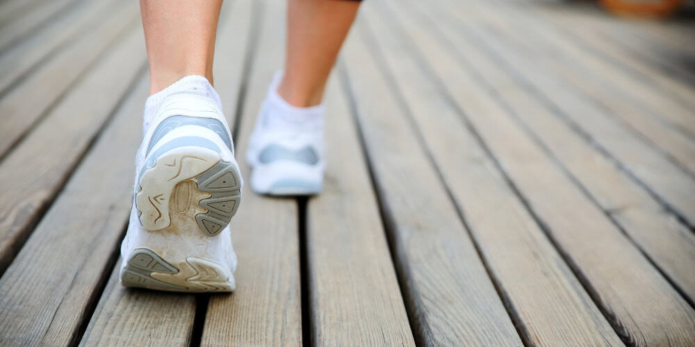 walking tennis shoes on boardwalk