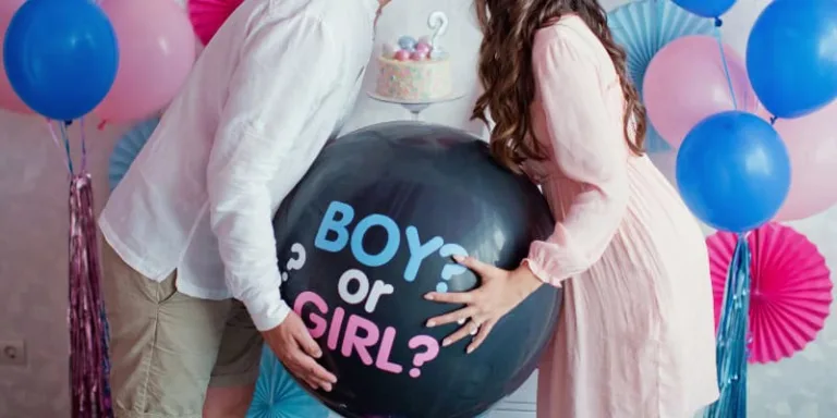 boy or girl gender reveal party with balloons