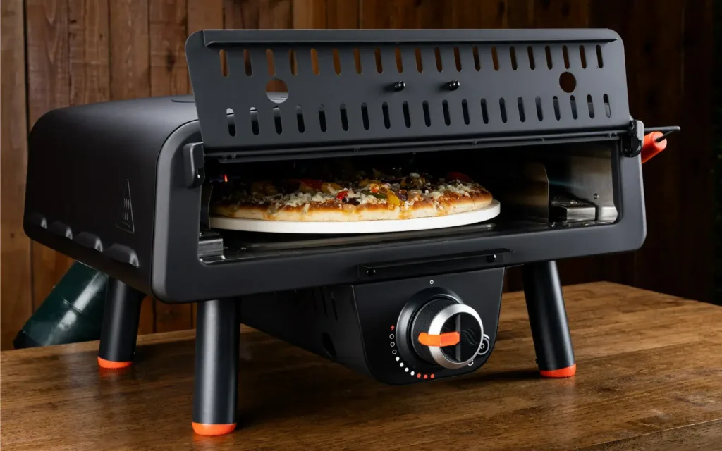 Portable pizza oven with pizza being cooked