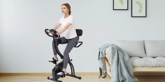 Woman exercising on stationary bike at home