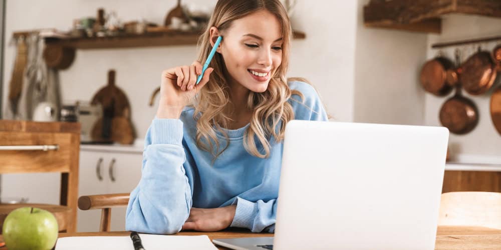 woman working at home on laptop on counter