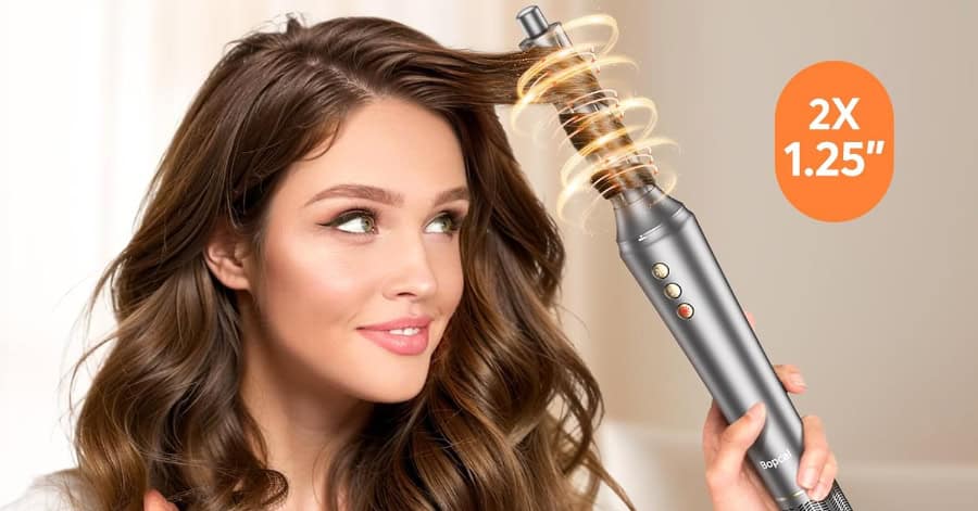 Woman styling hair with rotating curling iron.