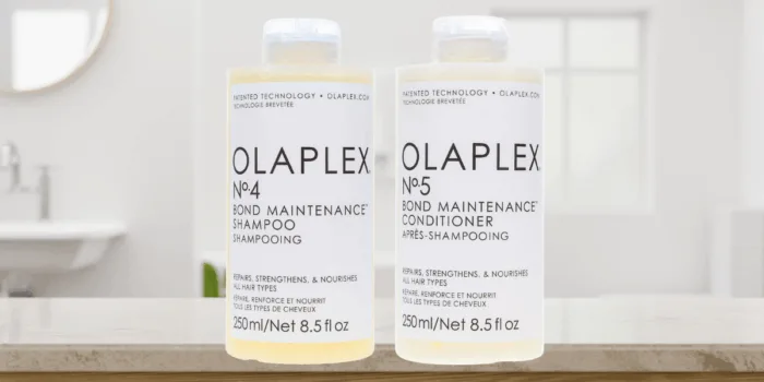 Olaplex shampoo and conditioner bottles on table.