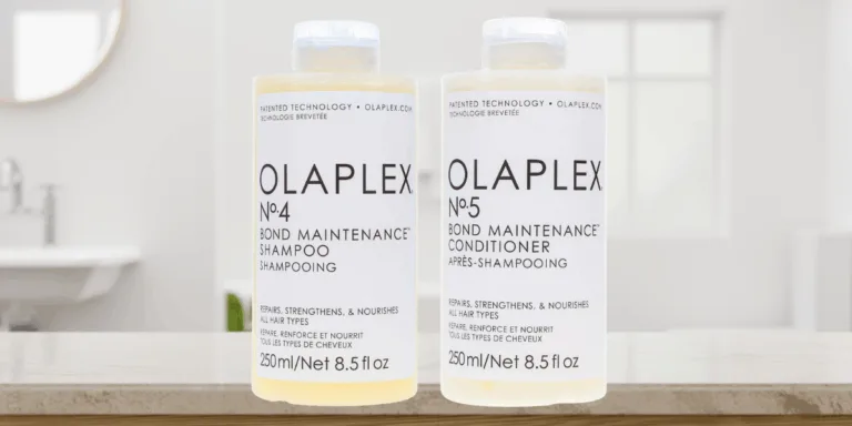 Olaplex shampoo and conditioner bottles on table.