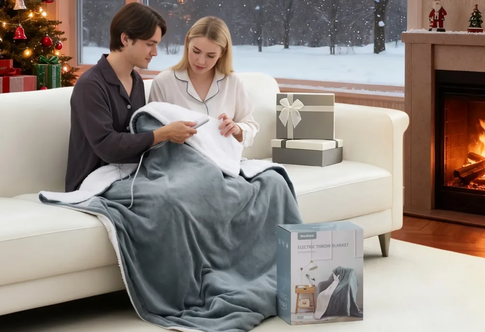 Couple using electric blanket in cozy living room.
