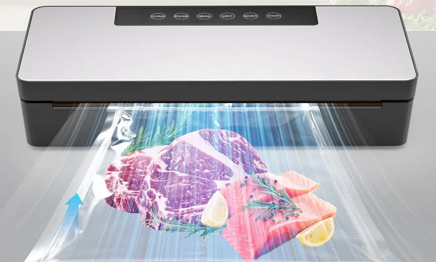 Vacuum sealer packaging raw meat and fish slices.