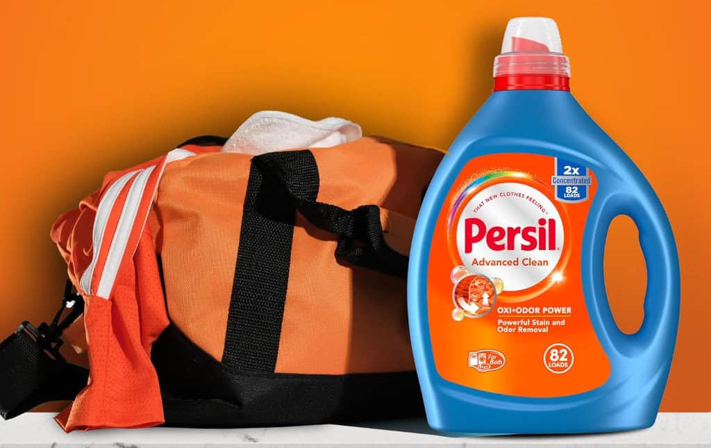 Laundry detergent with sports bag, orange background.