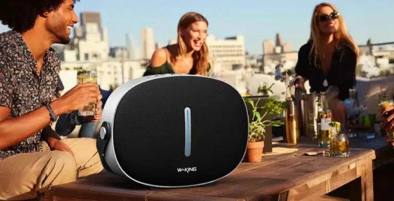 Portable speaker on rooftop party table.