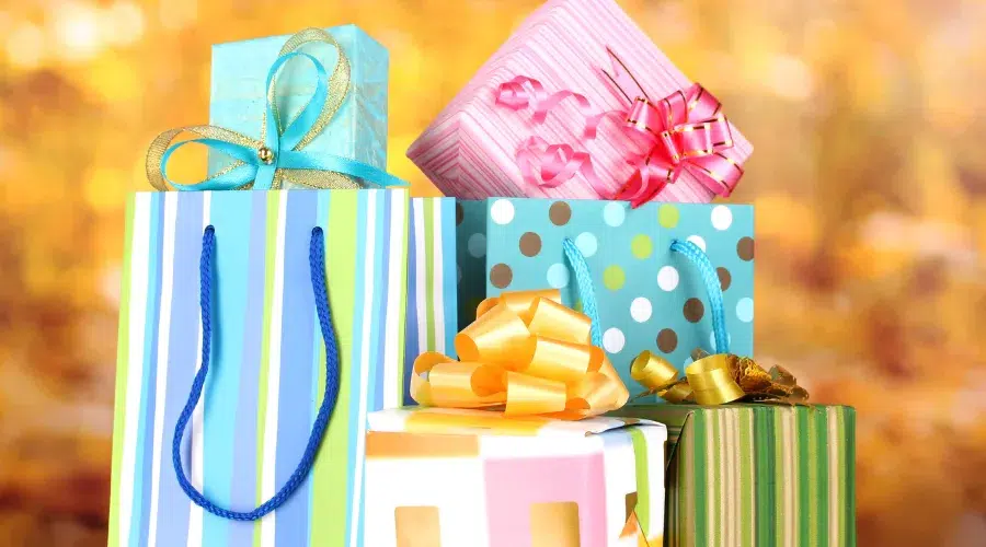 Colorful gift boxes and bags with ribbons.