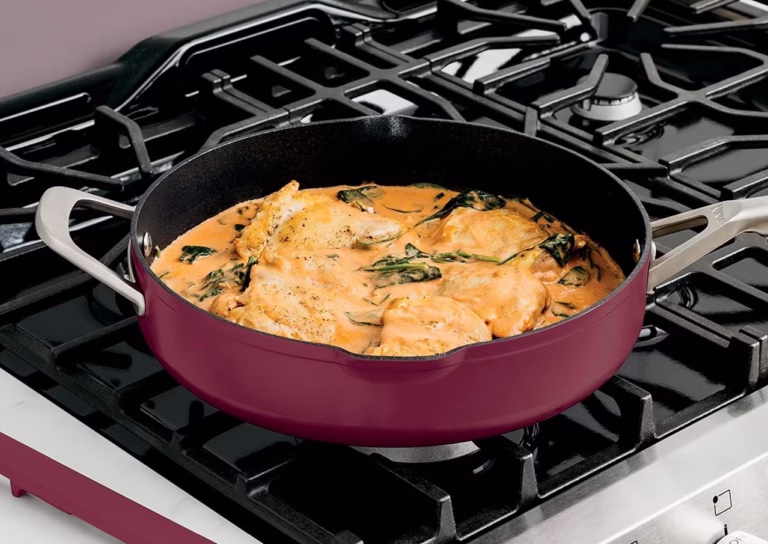 Chicken and spinach in saucepan on stove