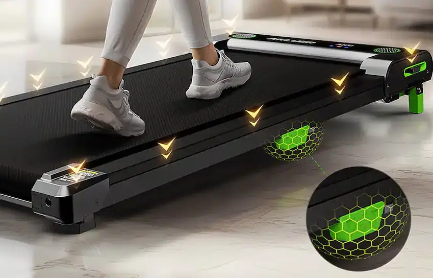 Person walking on a treadmill with green cushioning.