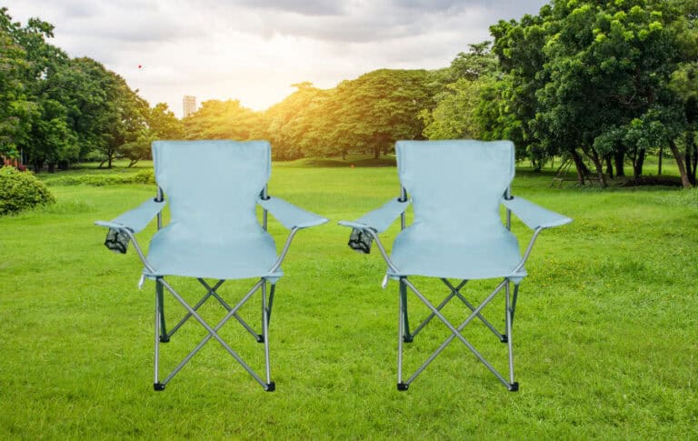 Two folding chairs on a grassy park field