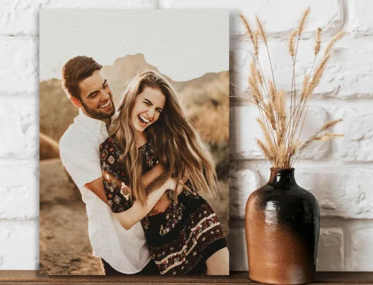 Smiling couple holding each other outdoors; earthy decor