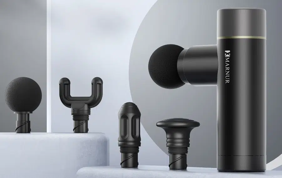 Massage gun with various attachments displayed.