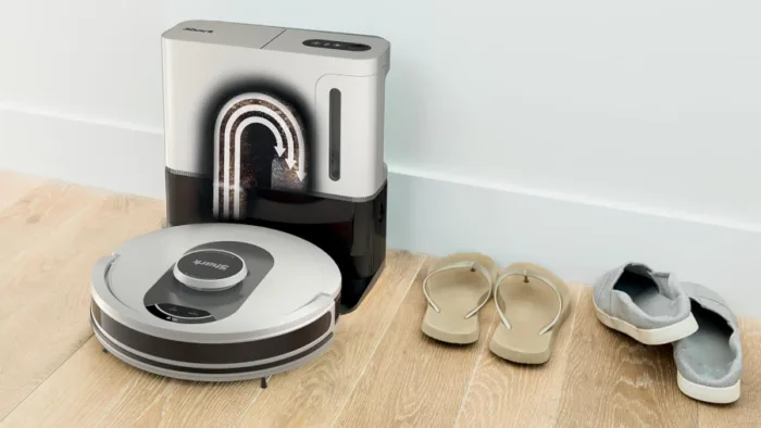 Robot vacuum with docking station and shoes nearby