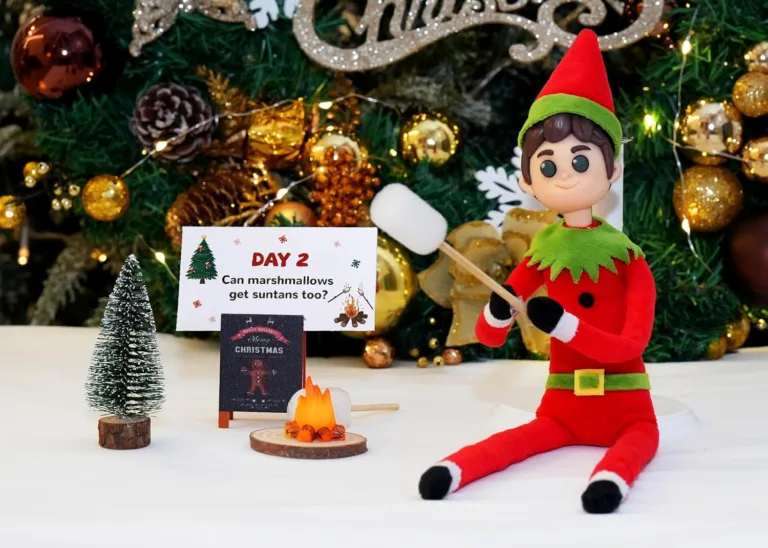 Elf roasting marshmallow by Christmas tree.