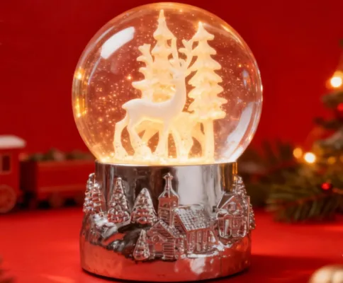 Illuminated deer snow globe with red background
