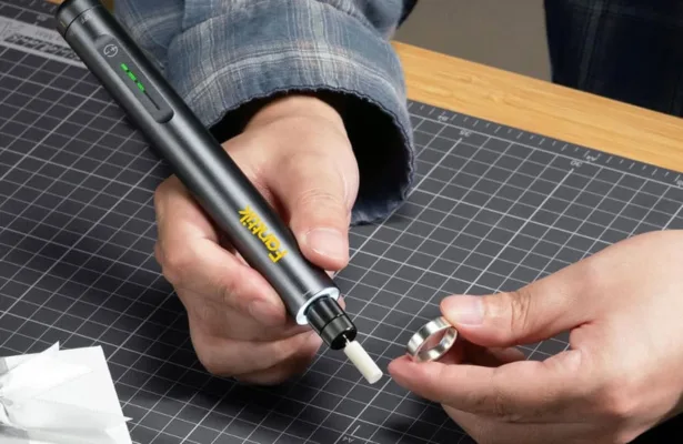 Soldering pen working on a metal ring.