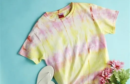 Colorful tie-dye t-shirt with flowers and sandals.