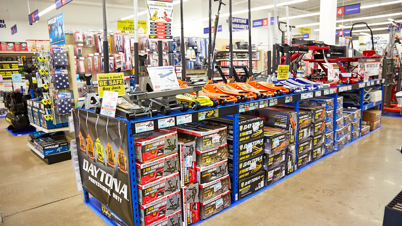 Store aisle with car jacks and accessories display.