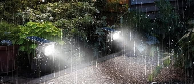 Solar lights illuminate garden path during rainstorm.